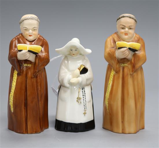 A pair of Royal Worcester candle extinguishers of a monk and one of a nun